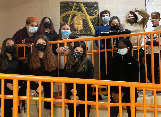 teens on orange stairs with masks