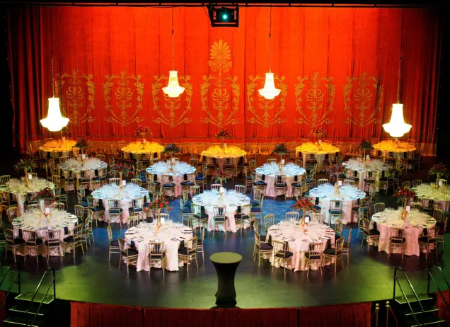 empty tables set for a meal on a stage