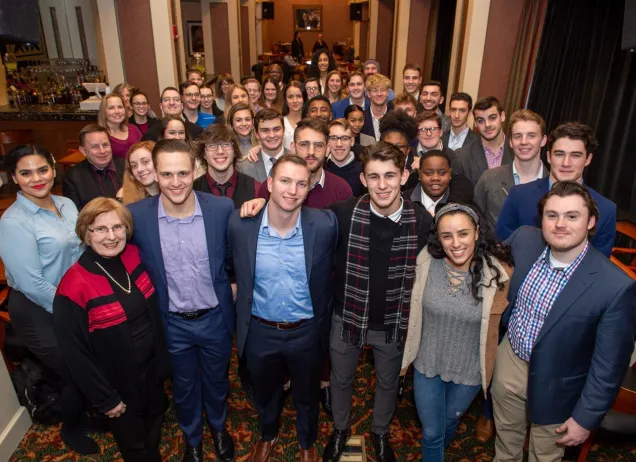 large group of young adults in a hallway