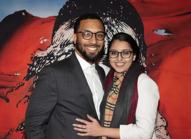two people in front of mural