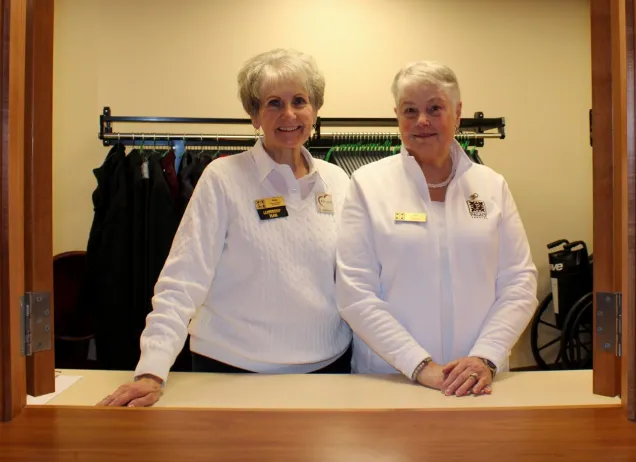 2 woman coat closet workers