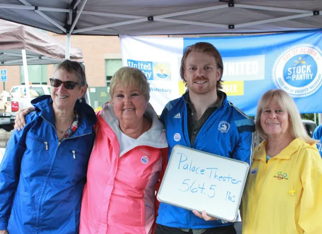 4 people outside with united way