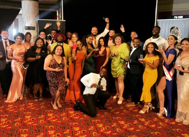 group of people holding trophies